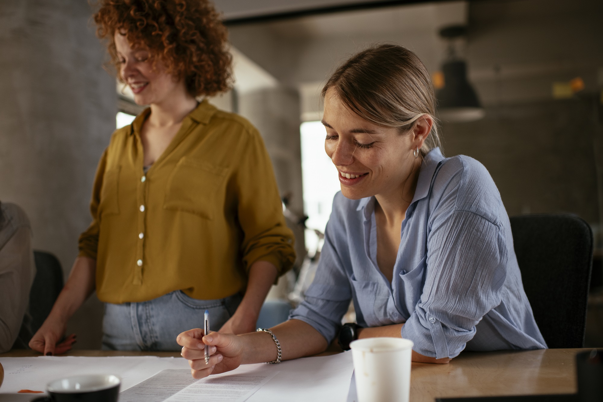 Woman wearing a blue shirt at a desk